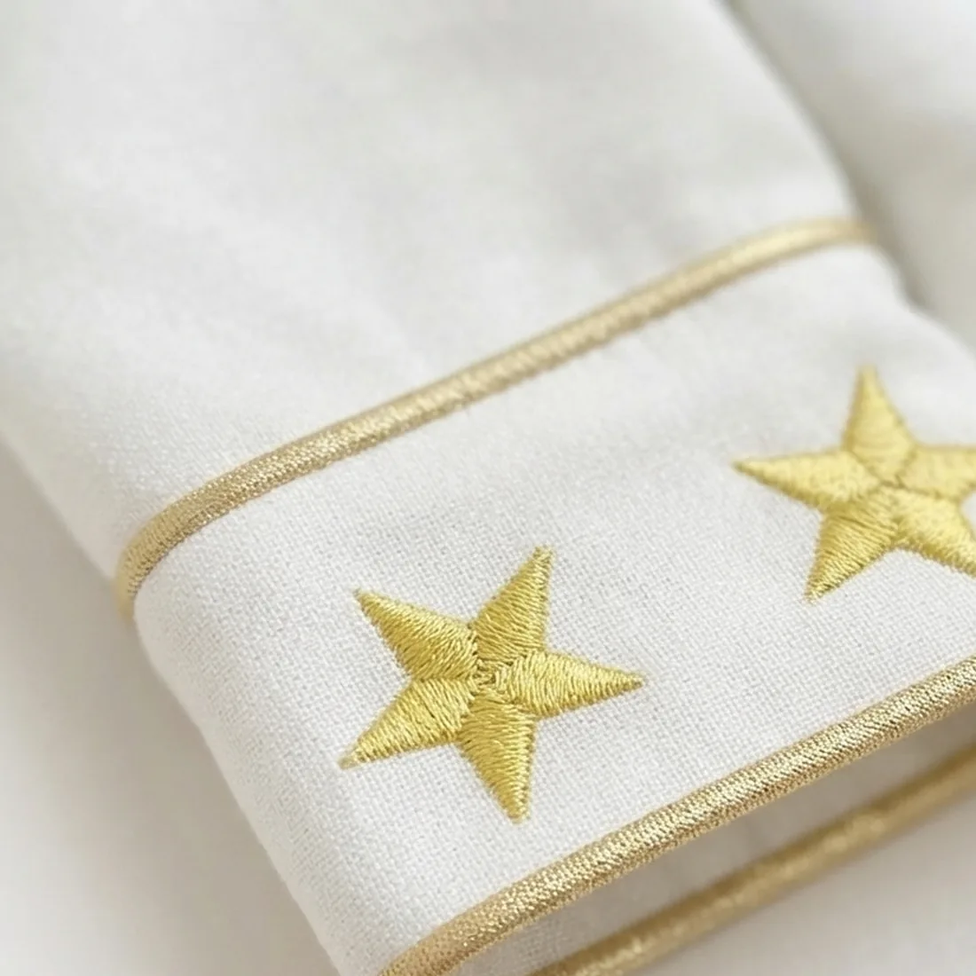 Punho com estrelas douradas bordadas